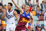 Tom Rockliff celebrates a goal for the Lions.