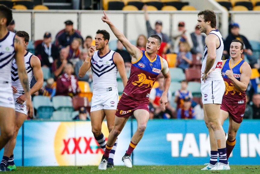 Tom Rockliff celebrates a goal for the Lions.