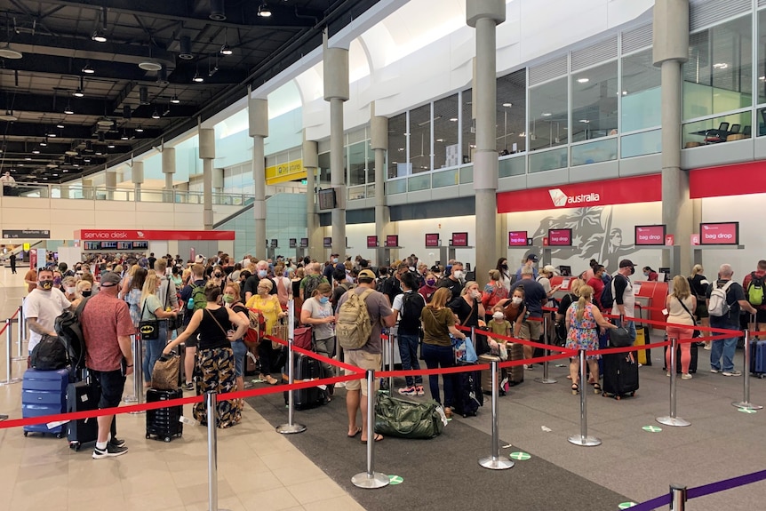 Hundreds of people in an airport terminal.