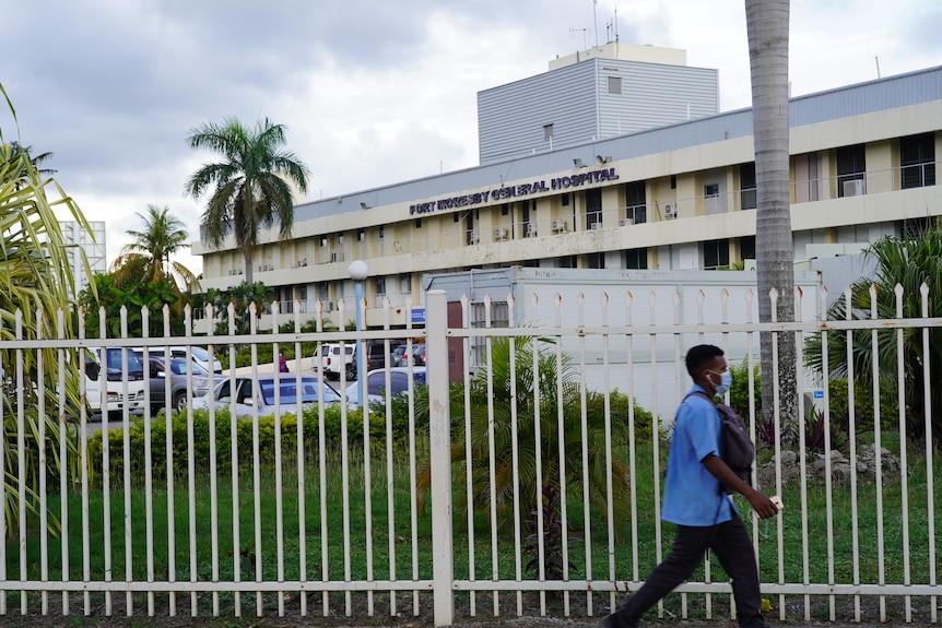 A person walks past the Port Moresby General Hospital.