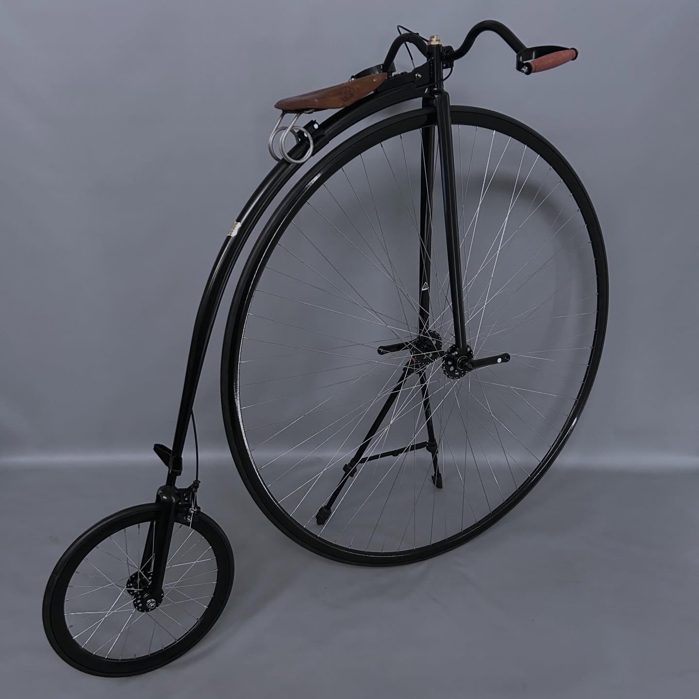 A beautiful black penny farthing coloured black.