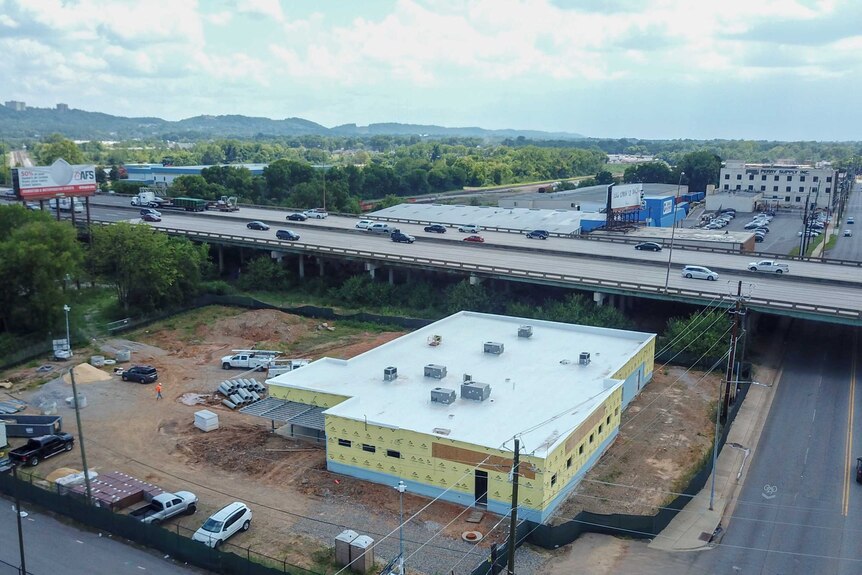 A half-built building next to a major highway