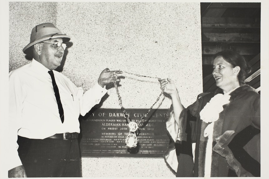 Dr Stack receiving the mayoral regalia from then outgoing Darwin mayor Tiger Brennan in 1975.
