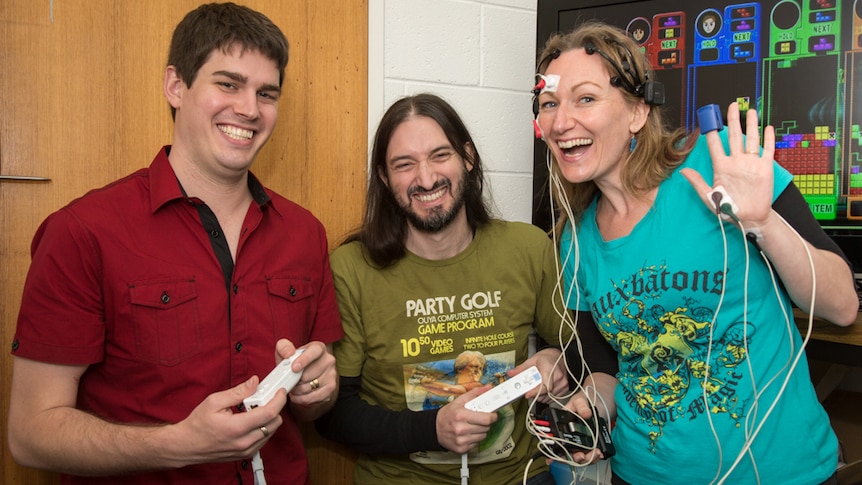 Emotions in video gaming is being tested by Ben Geelan (left), Dr Ian Lewis, and Dr Kristy de Salas (right).