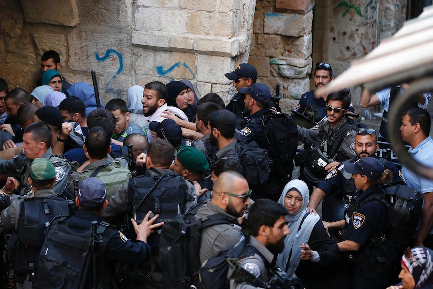 Israeli security forces block Palestinians at an entrance of east Jerusalem's al-Aqsa mosque
