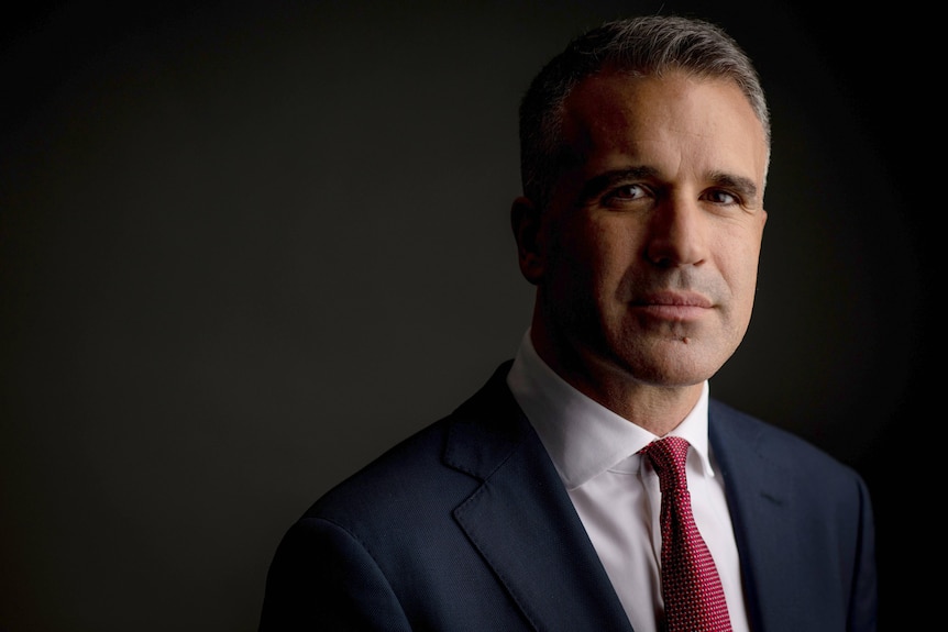 A portrait photo of a man in a suit and tie.