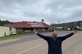Steven Hall stands in front of Dargo Hotel wearing mask