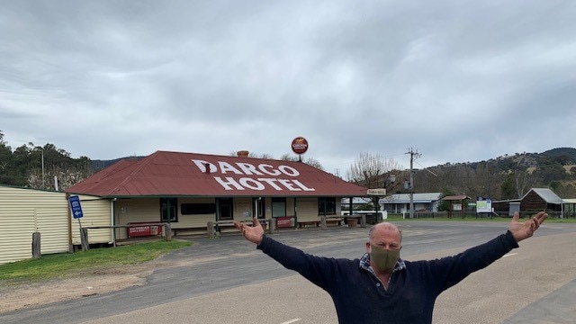 Steven Hall stands in front of Dargo Hotel wearing mask