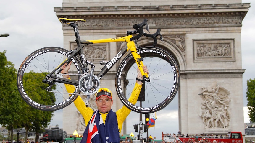 Australia's Cadel Evans holds his bicycle at the Arc de Triomphe after winning the Tour de France.