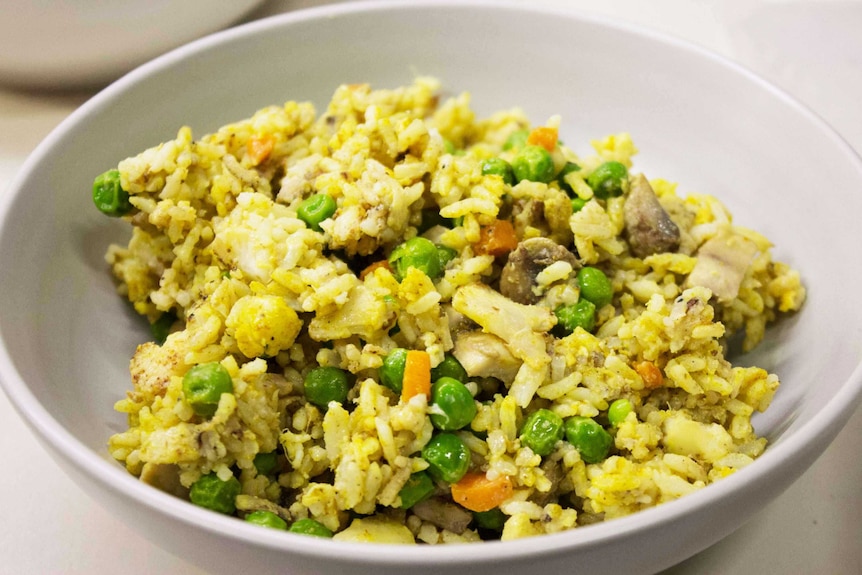 Fried rice in a bowl showing a simple meal that's easy to fit into your food preparation schedule and a good use of leftovers.