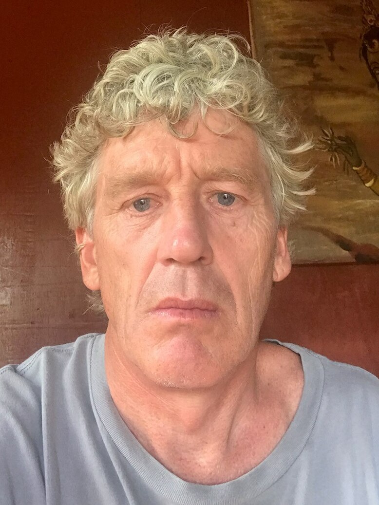 A selfie of a man with curly grey hair