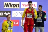 Australia's Mack Horton stands off the podium as Chinese swimmer Sun Yang and Italy's Gabriele Detti hold their medals.
