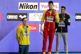 Australia's Mack Horton stands off the podium as Chinese swimmer Sun Yang and Italy's Gabriele Detti hold their medals.
