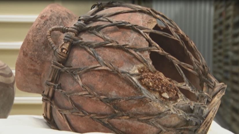 A broken ceramic jug wrapped in ornate cane