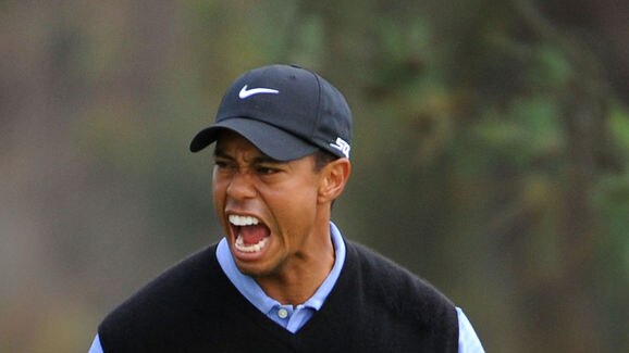 Tiger Woods celebrates sinking his long eagle putt