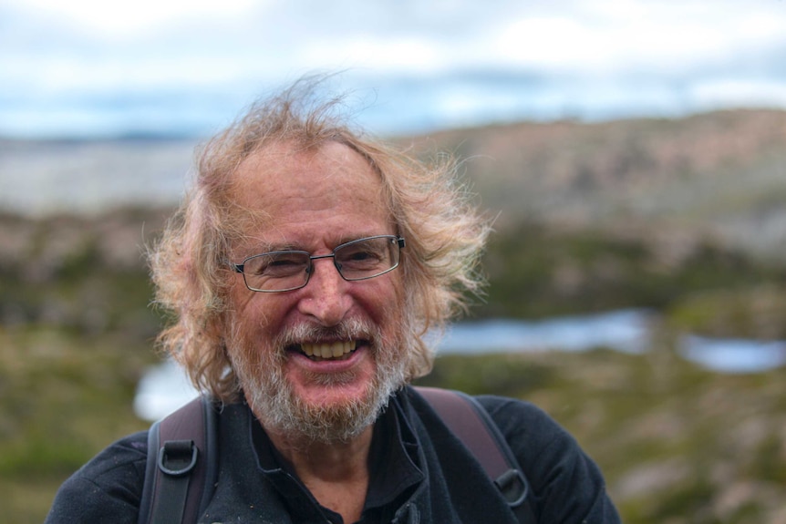 Distinguished professor Jamie Kirkpatrick, with the wind blowing in his faintly rainbow-coloured hair.