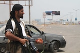 A Yemeni supporter of the separatist movement holds a gun