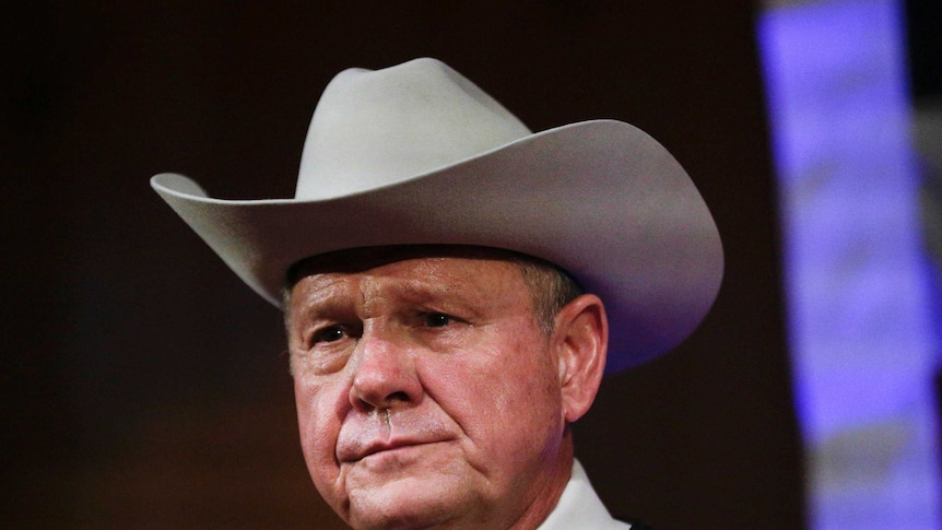 Roy Moore wears a cowboy hat. Tight headshot