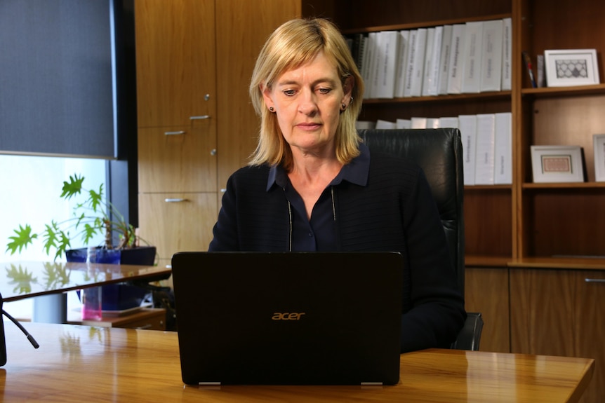 Sarah Court looks down at her computer