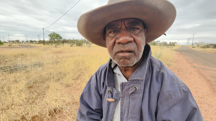 close up of indigenous man wearing broad-brim hat