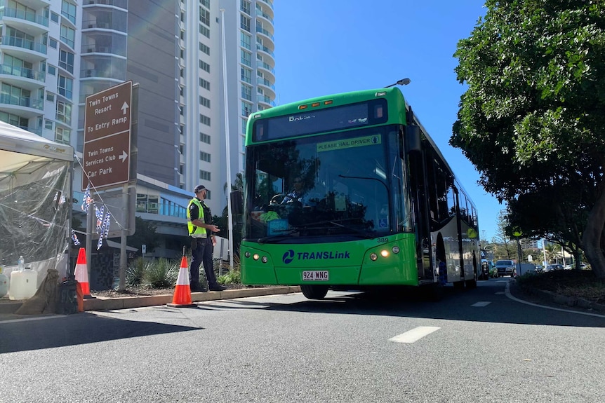 A bus at a police checkpoint.