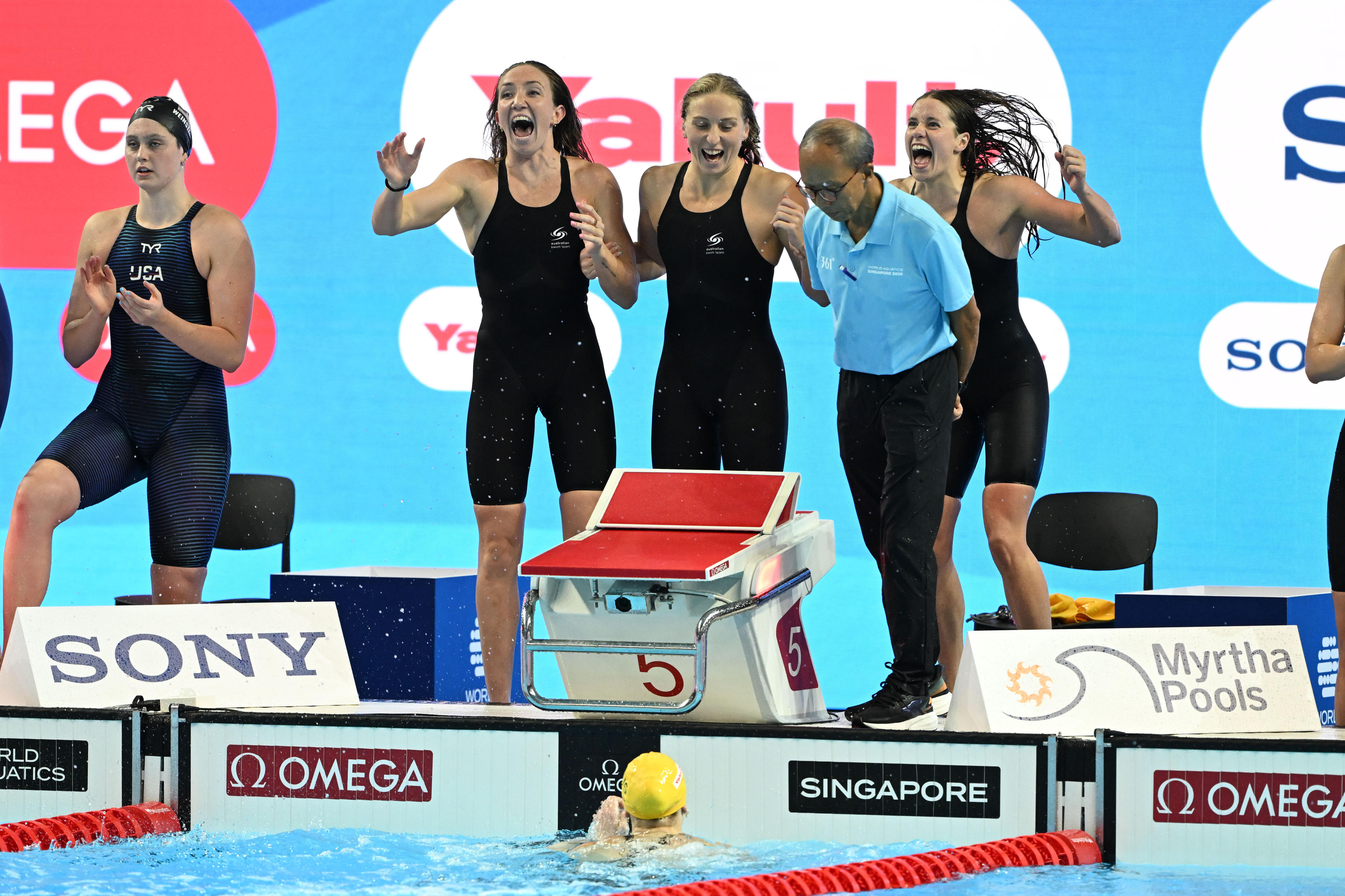 Lani Pallister, Jamie Perkins and Brittany Castelluzzo celebrate on the pool deck with Mollie O'Callaghan in the pool.