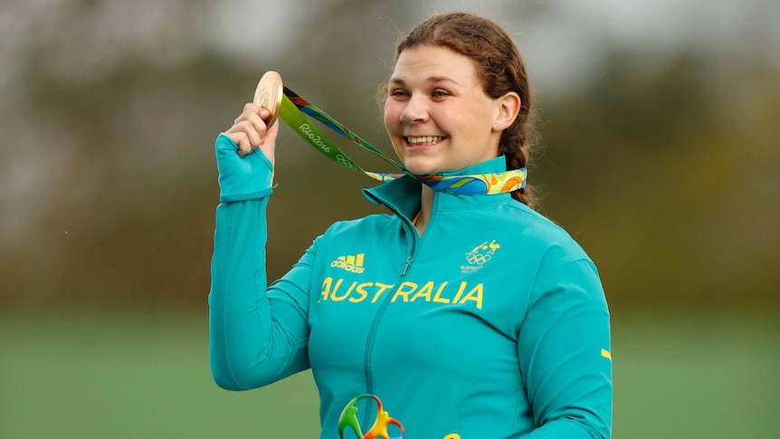 Catherine Skinner shows off her gold medal in trap shooting
