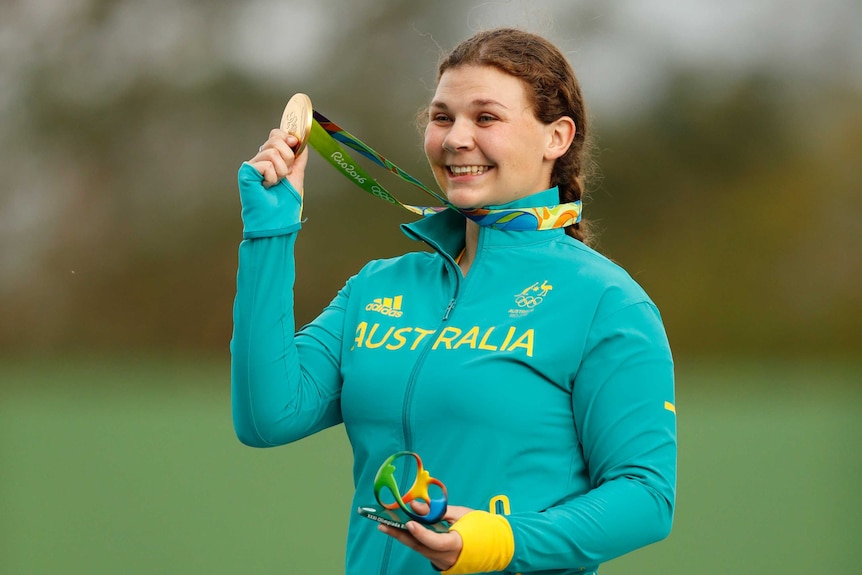 Catherine Skinner shows off her gold medal in trap shooting