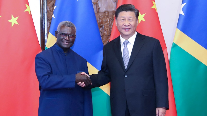Chinese President Xi Jinping shakes hands with Solomon Islands' Prime Minister Manasseh Sogavare in Beijing.