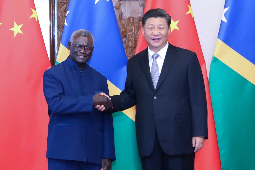 Chinese President Xi Jinping shakes hands with Solomon Islands' Prime Minister Manasseh Sogavare in Beijing.