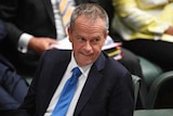 Bill Shorten smiles and looks to his left.