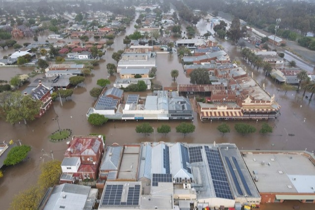 An aerial view of Rochester's main streets flooded with brown water.