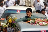 Aung San Suu Kyi receives flowers from supporters in the village of Yae Phu, Burma.