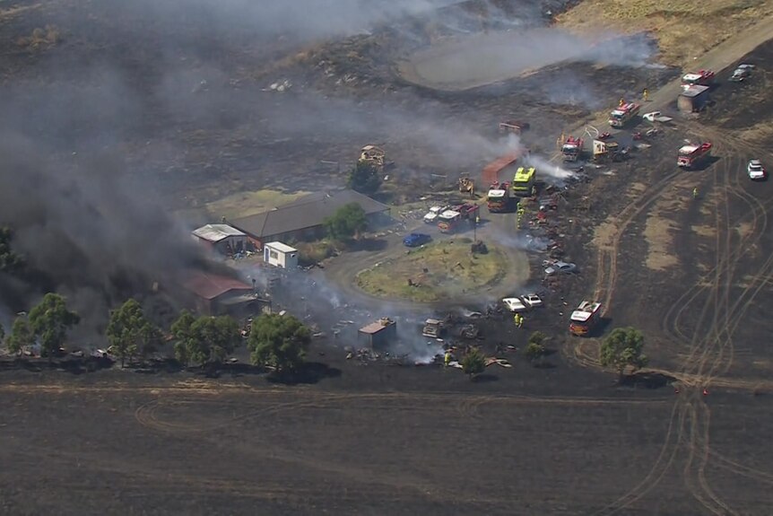 Dozens of emergency vehicles respond to a grassfire.