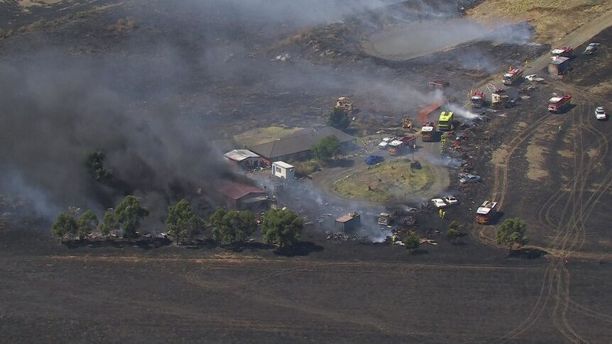Dozens of emergency vehicles respond to a grassfire.