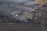 Dozens of emergency vehicles respond to a grassfire.
