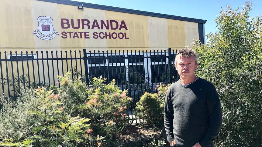 Craig Unthank stands outside one of the buildings at Buranda State School.