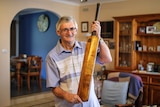 John Clancey with his Bodyline cricket bat signed by the entire Australian and English teams.