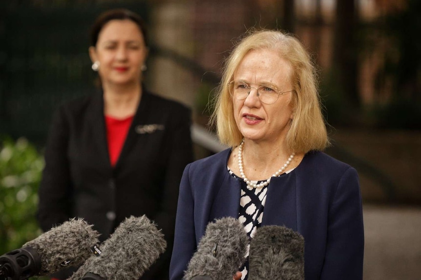 Dr Jeannette Young speaks at a media conference with Annastacia Palaszczuk looking on in the background.