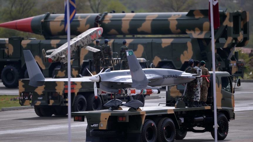 Pakistani soldiers travel on vehicles carrying ballistic missiles during a military parade in Islamabad