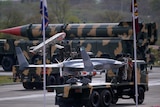 Pakistani soldiers travel on vehicles carrying ballistic missiles during a military parade in Islamabad