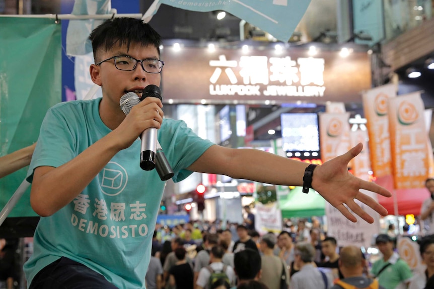 Hong Kong student activist Joshua Wong appears at a rally.