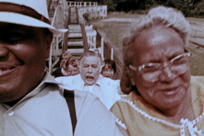 Film still of Lincoln Maazel screaming on a rollercoaster with people sitting in front and behind him in The Amusement Park