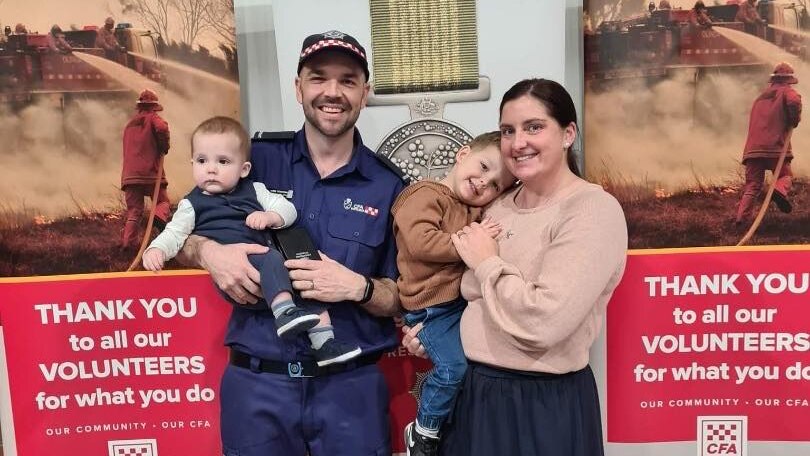 A man in CFA uniform with woman and two toddler boys.