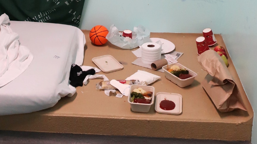 Rotting food on a table inside a bedroom