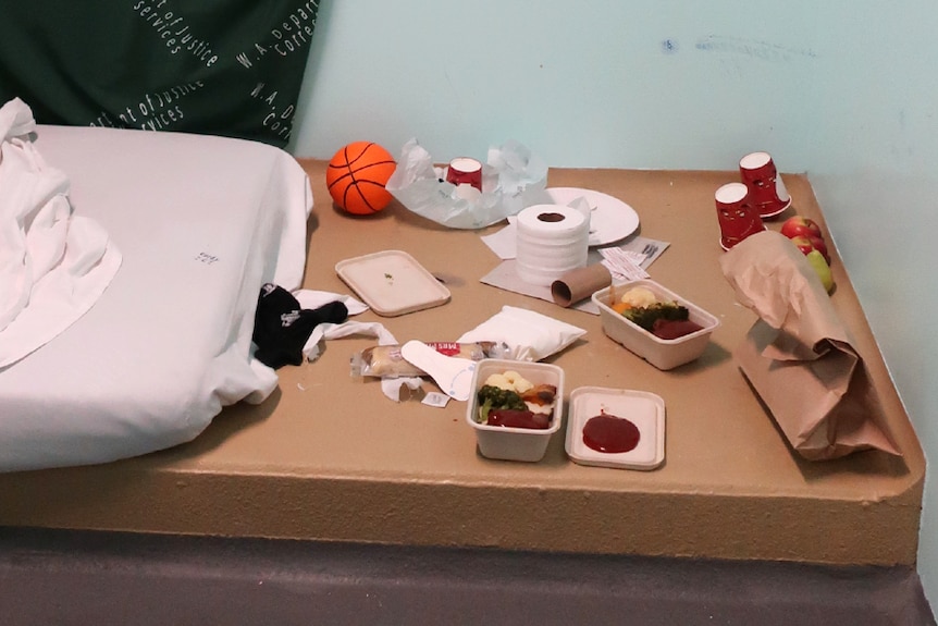 Rotting food on a table inside a bedroom