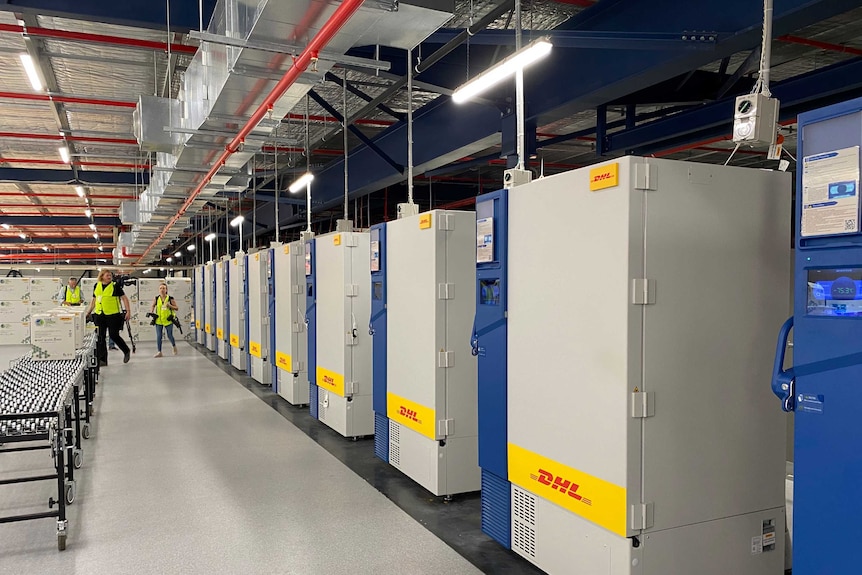 Freezers in a row inside a modern-looking warehouse.