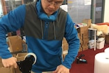 Ming Ouyang packs an order for a customer.
