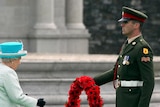 Queen Elizabeth II lays a wreath of poppy flowers at the Irish War Memorial Garden