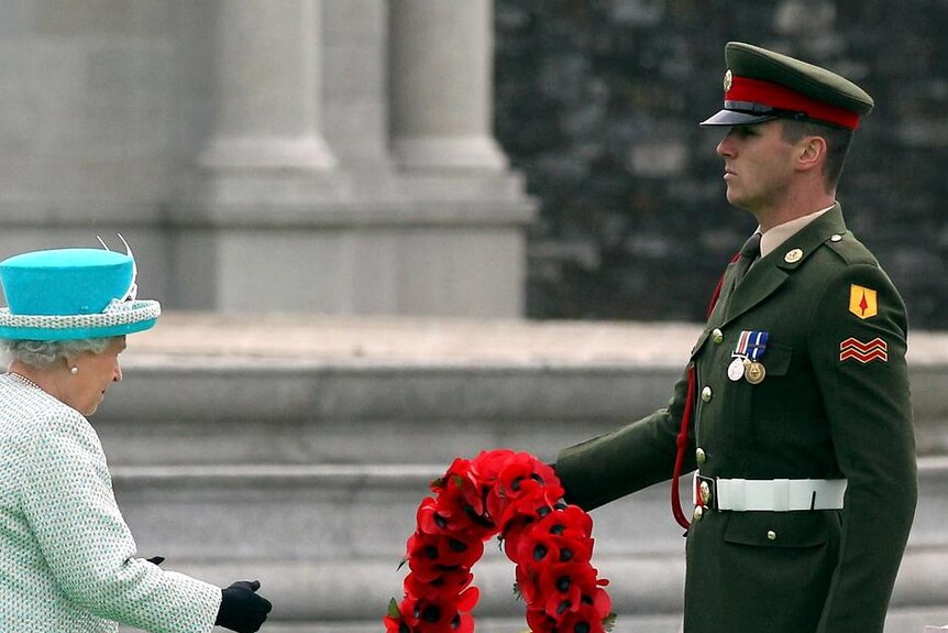 Queen Elizabeth II lays a wreath of poppy flowers at the Irish War Memorial Garden